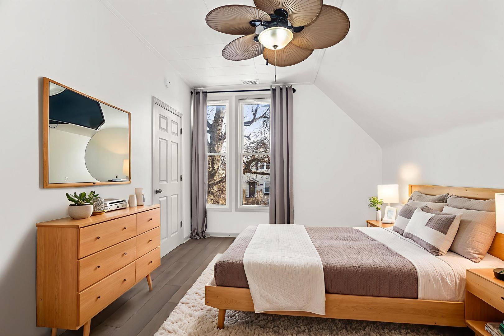 2846 North Troy Street, Unit 2 Chicago, IL 60618 - Photo 10 of 18 a bedroom with a bed and wooden floor