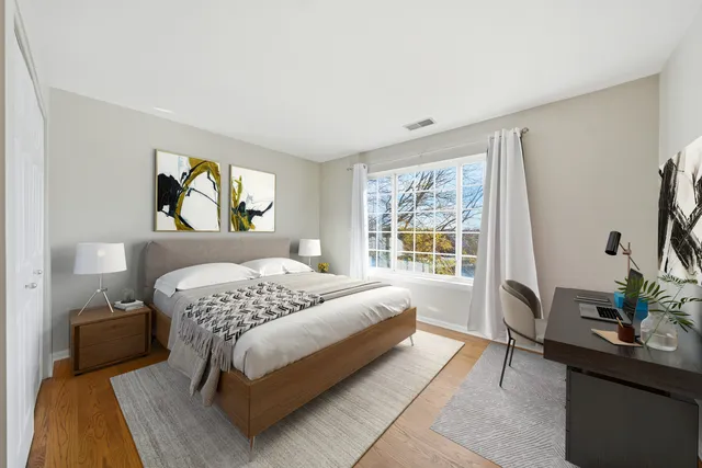 a bedroom with a bed and a potted plant