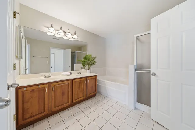 a spacious bathroom with a double vanity sink and a mirror