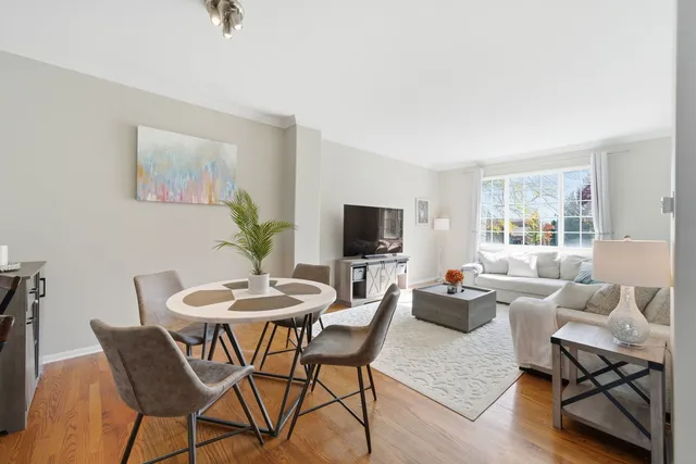 a living room with furniture a flat screen tv and a window