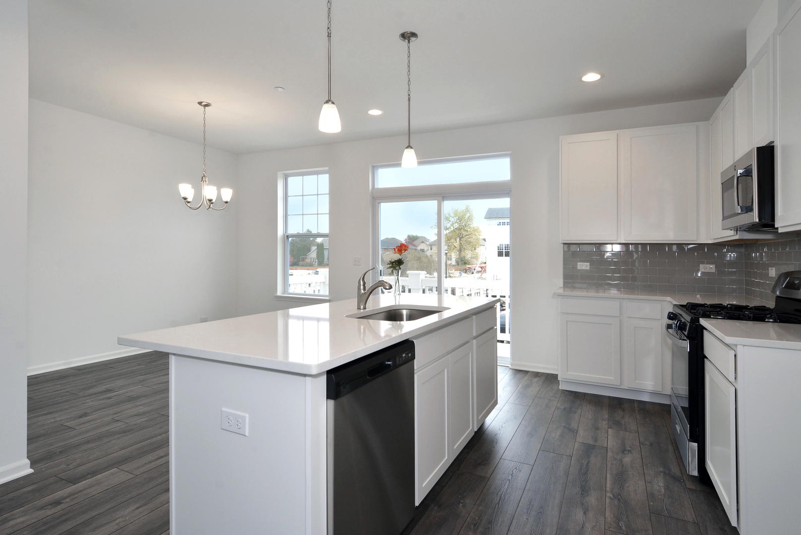 202 Timberleaf Circle Roselle, IL 60172 - Photo 6 of 22 a kitchen with kitchen island granite countertop a sink appliances and cabinets