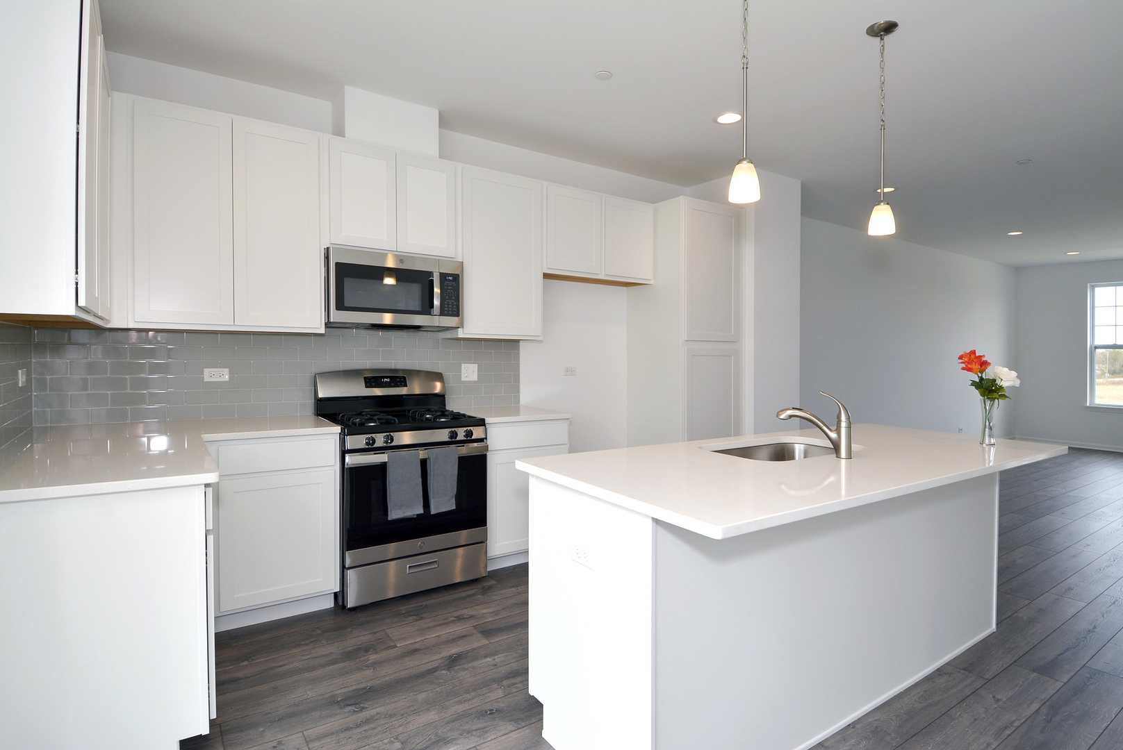 202 Timberleaf Circle Roselle, IL 60172 - Photo 7 of 22 a kitchen with stainless steel appliances granite countertop a sink a stove a microwave oven a refrigerator with white cabinets and wooden floor