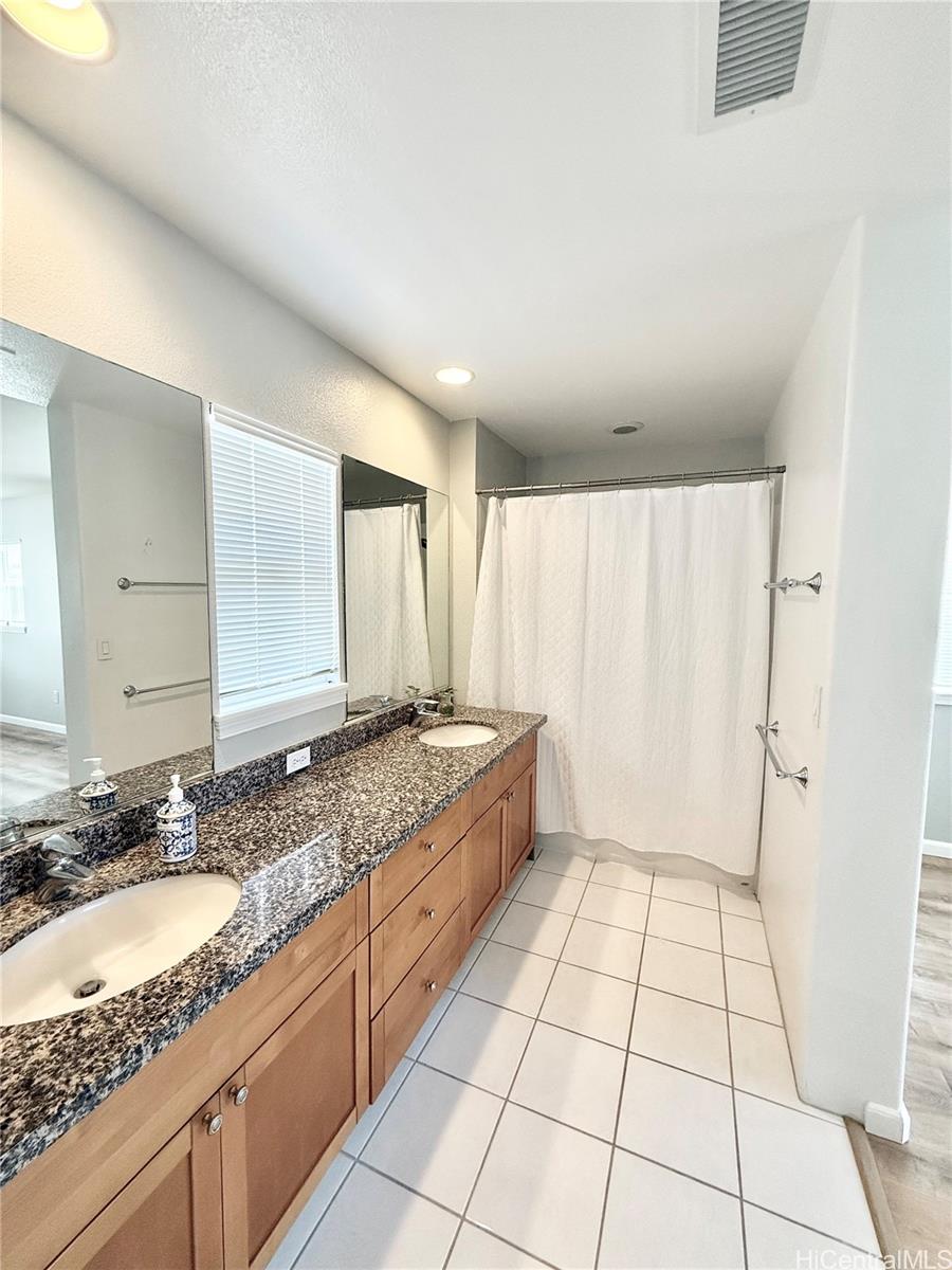 580 Lunalilo Home Road, Unit B340 Honolulu, HI 96825 - Photo 12 of 21 a spacious bathroom with a granite countertop sink a mirror and a bathtub