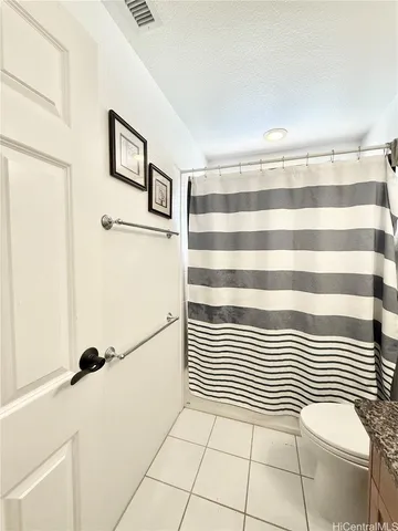 a view of a livingroom with white cabinets and a wooden floor