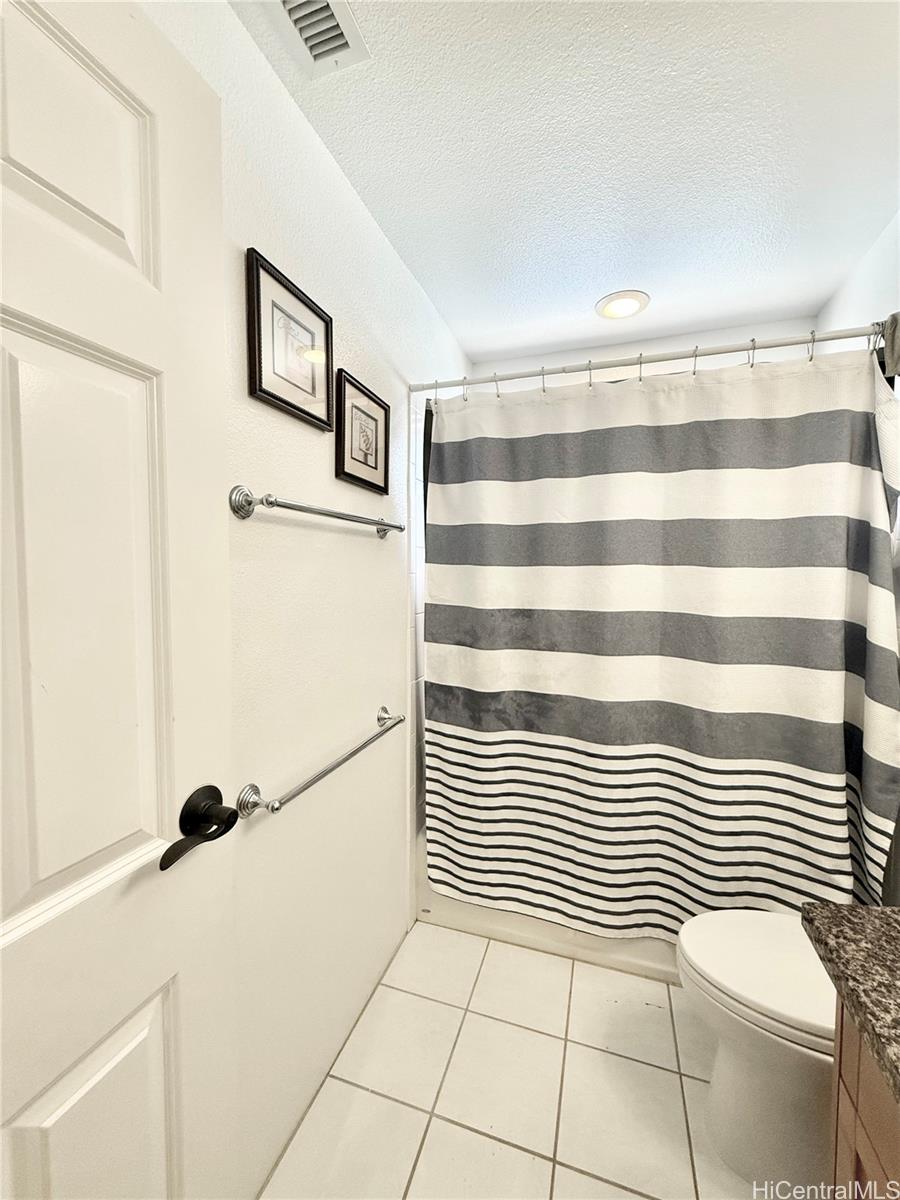 580 Lunalilo Home Road, Unit B340 Honolulu, HI 96825 - Photo 15 of 21 a view of a livingroom with white cabinets and a wooden floor