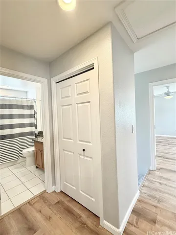 a view of a room with wooden floor and cabinet