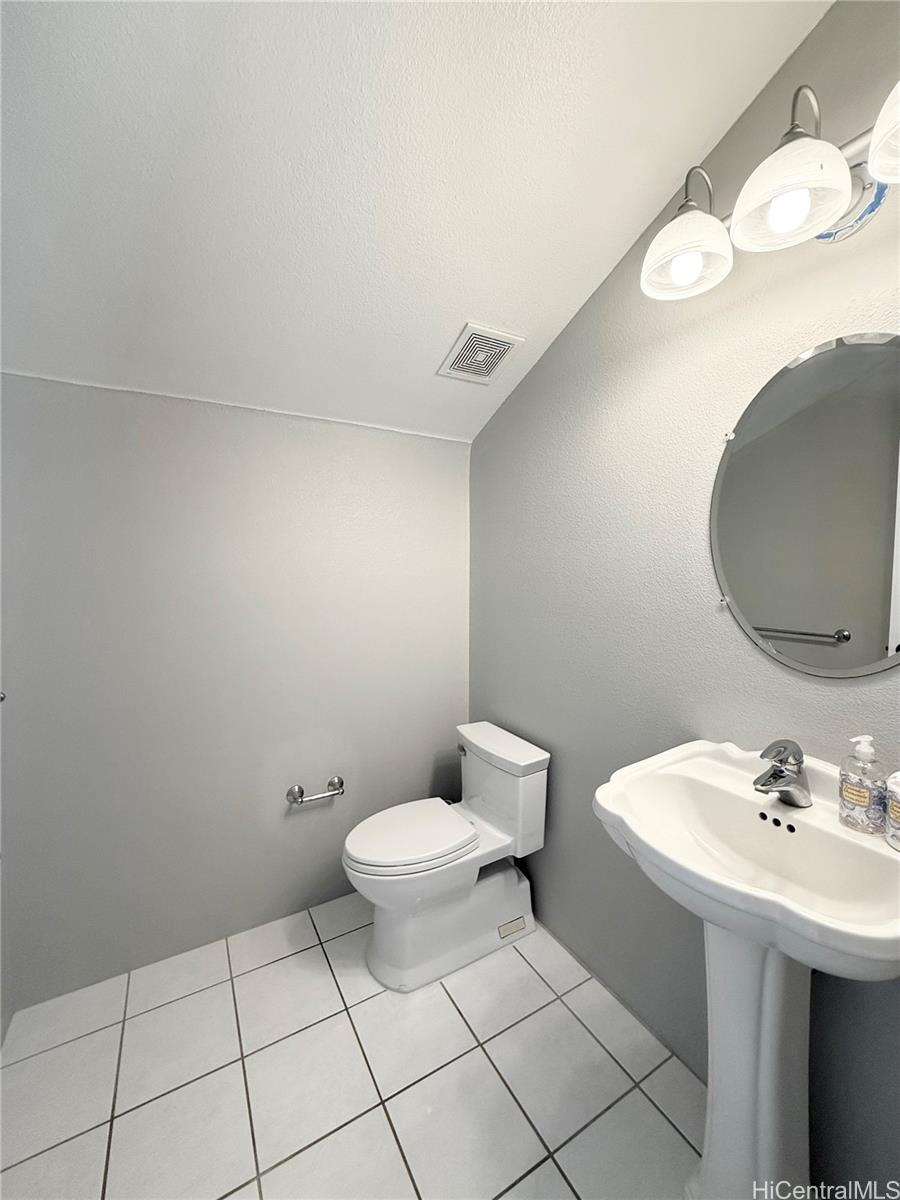 580 Lunalilo Home Road, Unit B340 Honolulu, HI 96825 - Photo 18 of 21 a bathroom with a sink a toilet and mirror