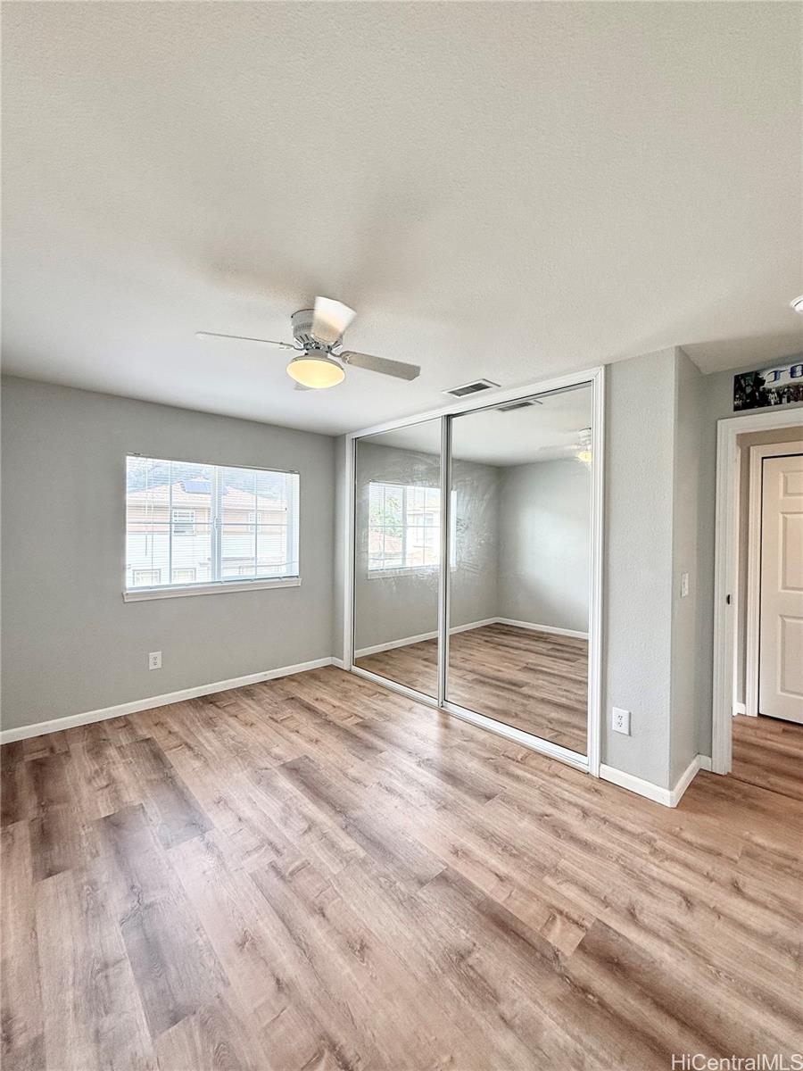 580 Lunalilo Home Road, Unit B340 Honolulu, HI 96825 - Photo 19 of 21 a view of an empty room with window and wooden floor