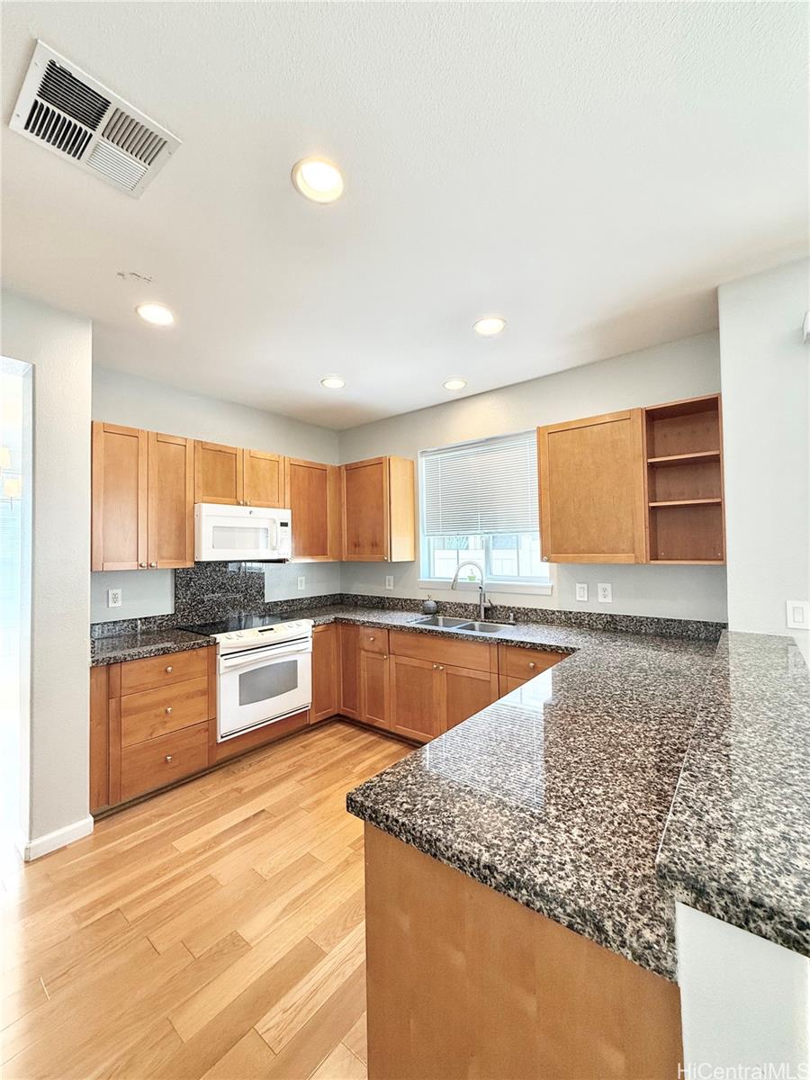580 Lunalilo Home Road, Unit B340 Honolulu, HI 96825 - Photo 8 of 21 a large kitchen with granite countertop a large counter top space and stainless steel appliances