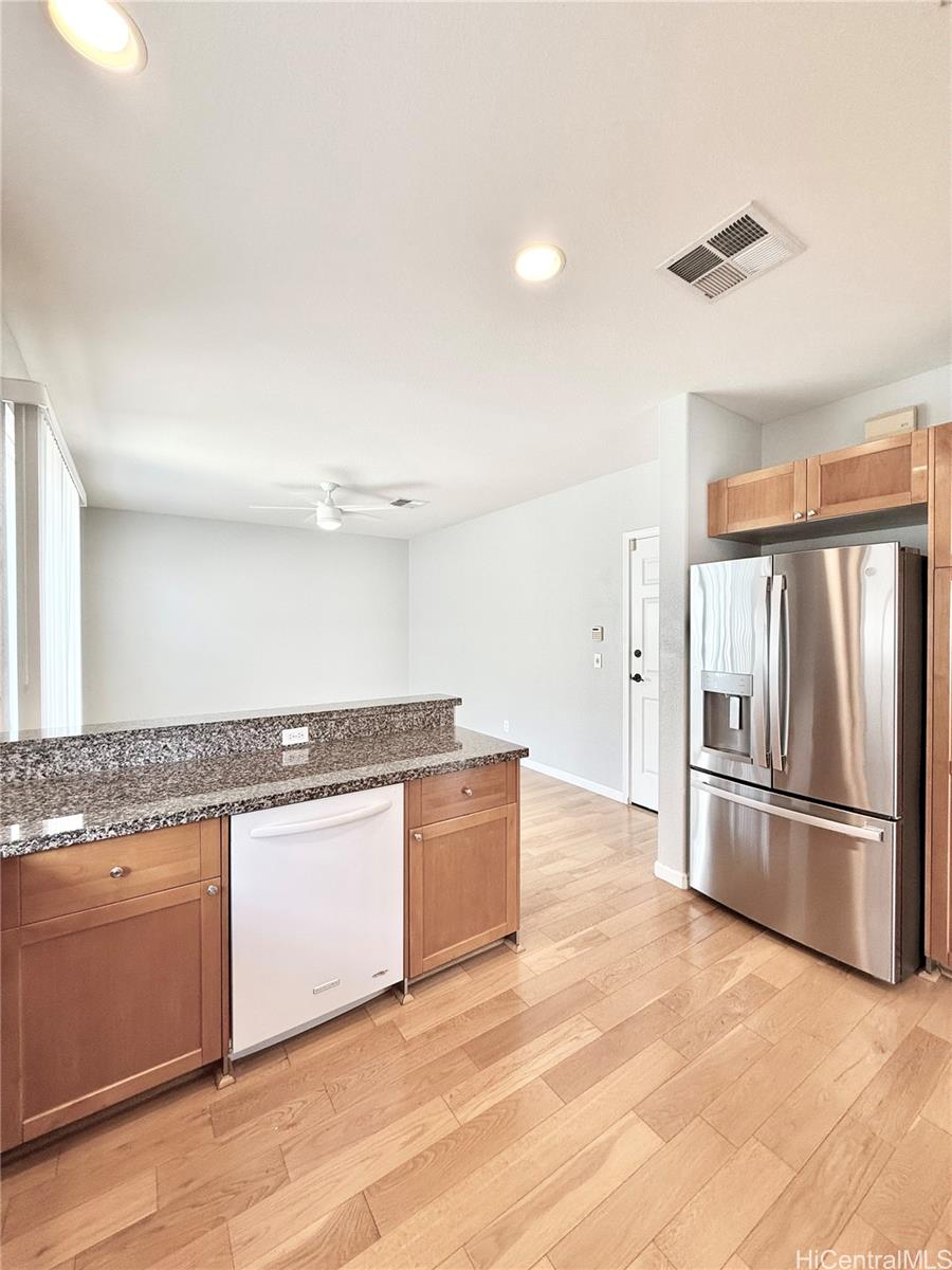 580 Lunalilo Home Road, Unit B340 Honolulu, HI 96825 - Photo 9 of 21 a kitchen with granite countertop a refrigerator and a stove top oven