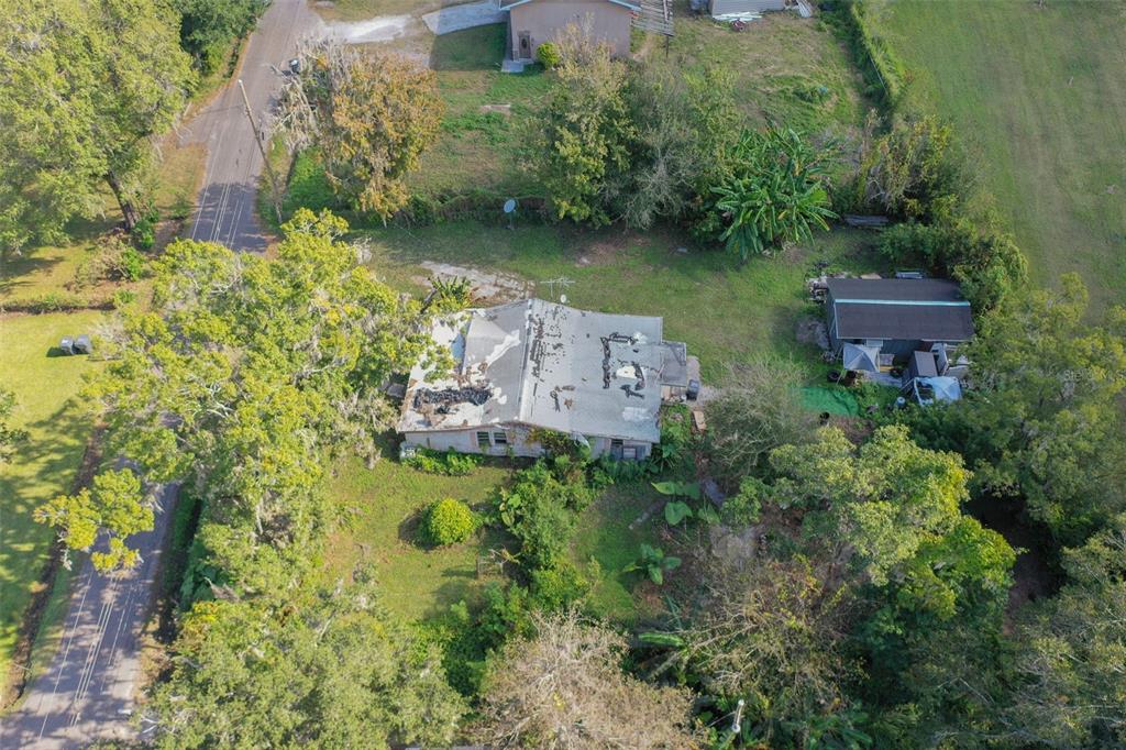 3346 Strickland Road Lakeland, FL 33810 - Photo 14 of 16 an aerial view of a house with a yard lake and outdoor seating