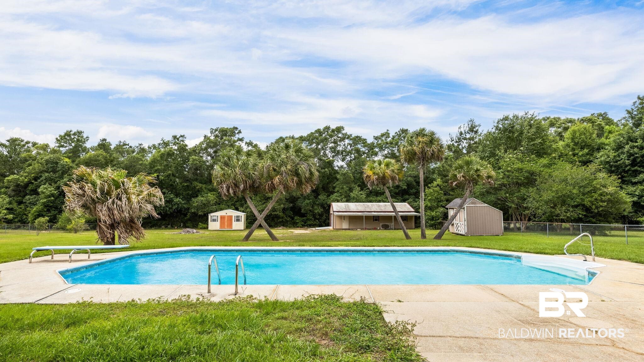 15096 Highland Circle Foley, AL 36535 - Photo 6 of 52 In-ground swimming pool with concrete surround