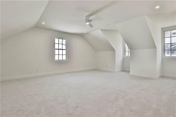 an empty room with ceiling fan and window