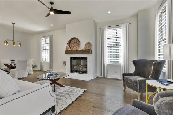 a living room with fireplace furniture and a wooden floor