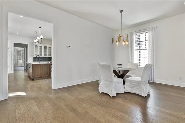 a large kitchen with kitchen island a large counter space a sink stainless steel appliances and cabinets