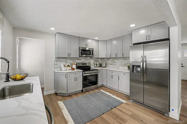 a kitchen with a sink stainless steel appliances and counter space