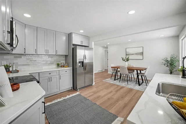 a kitchen with refrigerator cabinets and a sink