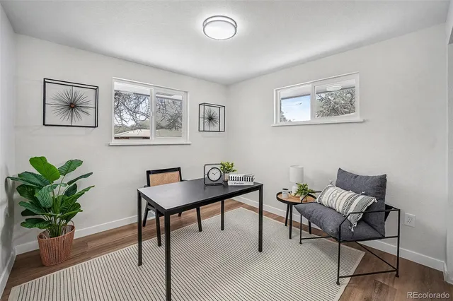 a view of a work space with furniture and wooden floor