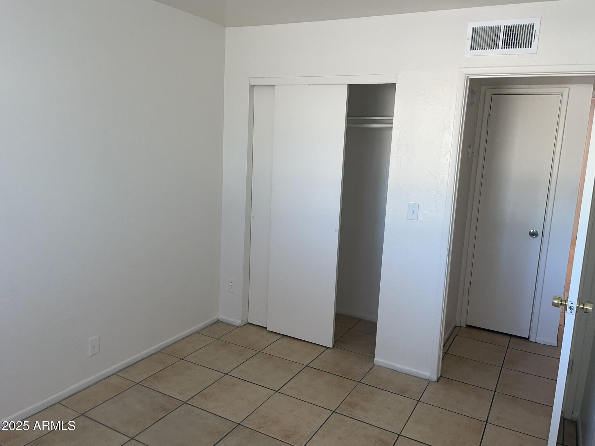 2002 East Sweetwater Avenue, Unit 108 Phoenix, AZ 85022 - Photo 11 of 25 an empty room with closet