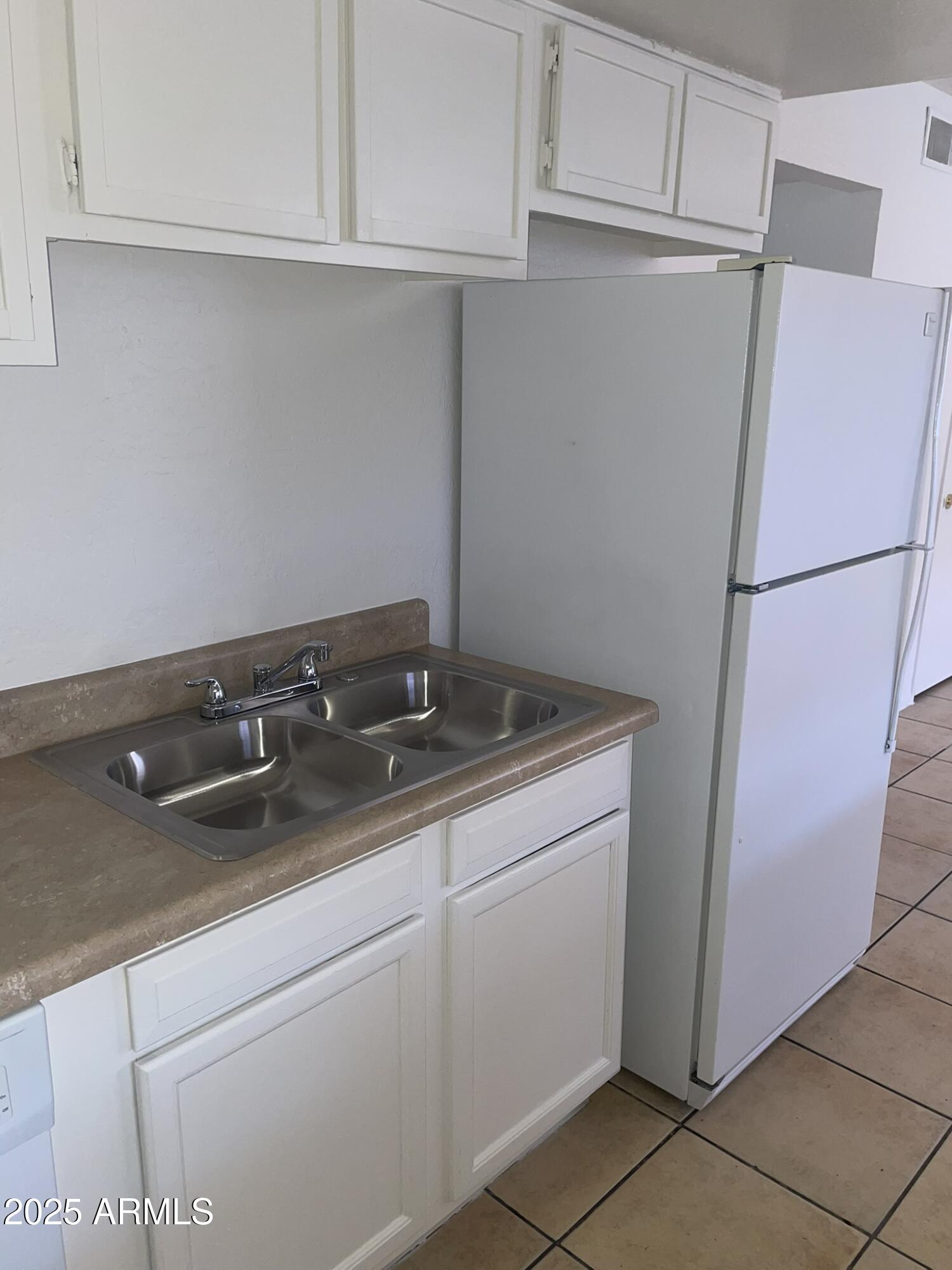 2002 East Sweetwater Avenue, Unit 108 Phoenix, AZ 85022 - Photo 16 of 25 a kitchen with a sink and refrigerator