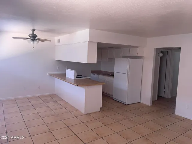 a kitchen with stainless steel appliances a refrigerator and microwave