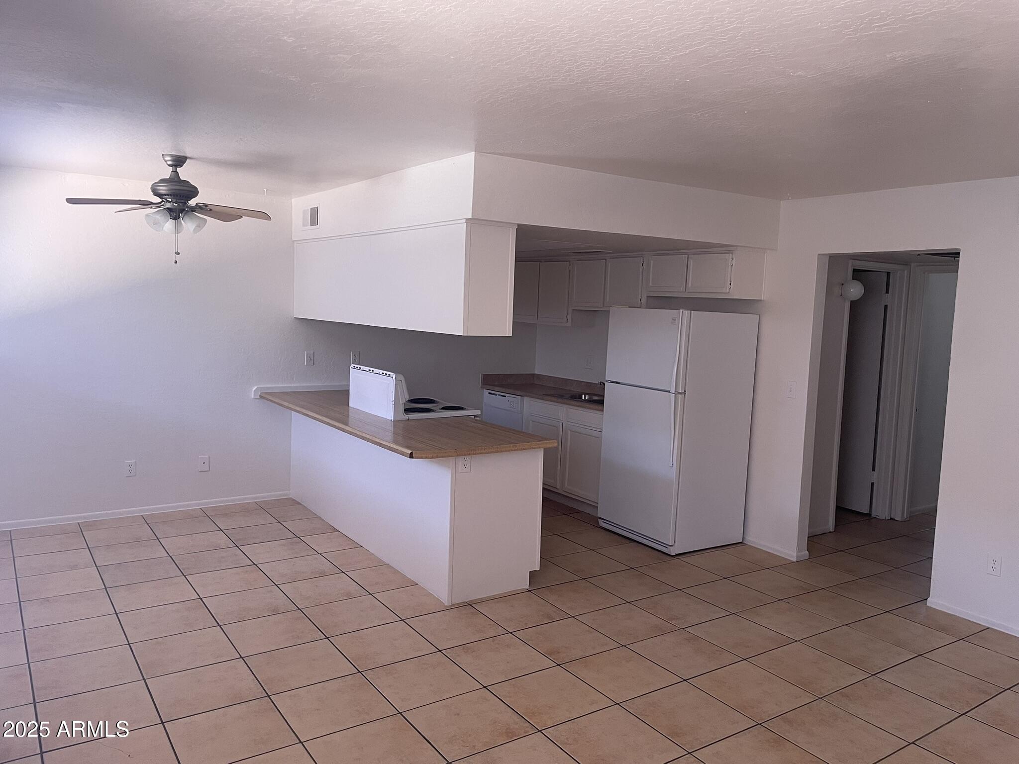 2002 East Sweetwater Avenue, Unit 108 Phoenix, AZ 85022 - Photo 2 of 25 a kitchen with stainless steel appliances a refrigerator and microwave