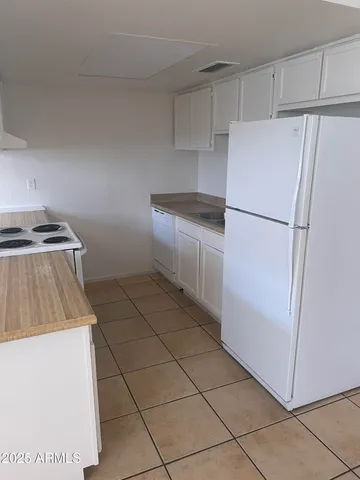 a kitchen with a refrigerator and a stove