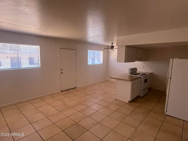 a room with a washing machine and cabinets