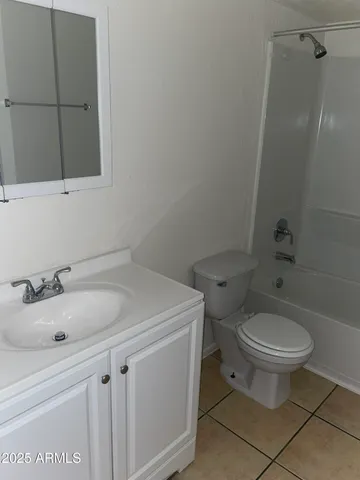 a bathroom with a sink toilet and a mirror