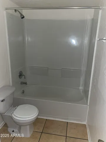 a bathroom with a toilet and shower