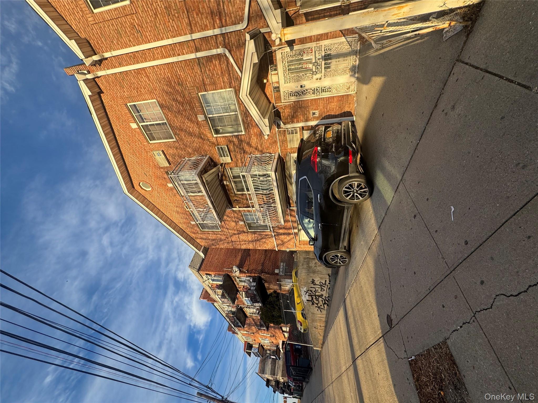87-13 164th Street Queens, NY 11432 - Photo 2 of 2 a car parked in front of a building