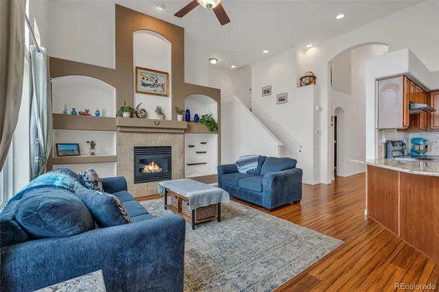 a living room with furniture and a fireplace