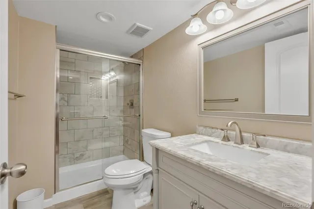 a bathroom with a sink toilet and shower