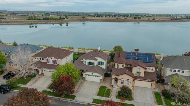 an aerial view of a houses with ocean view