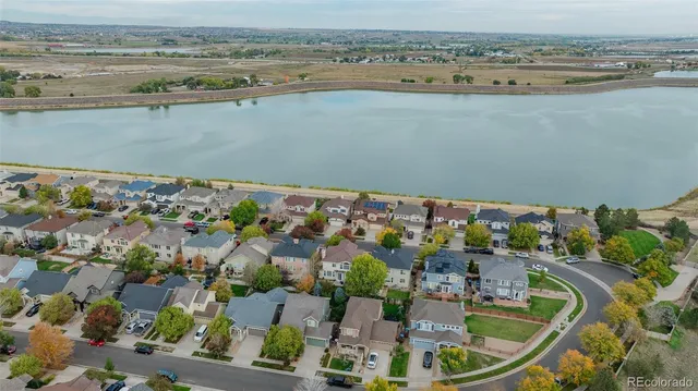 an aerial view of multiple houses with yard