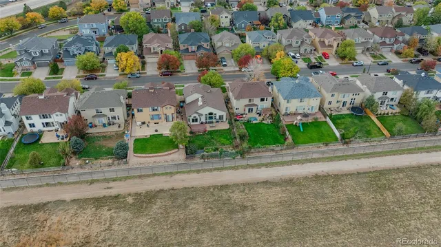 an aerial view of residential houses with street