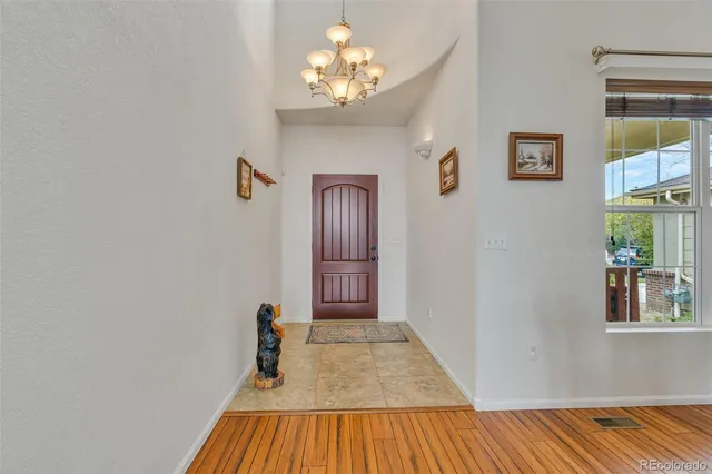 a view of a bedroom with wooden floor and a window