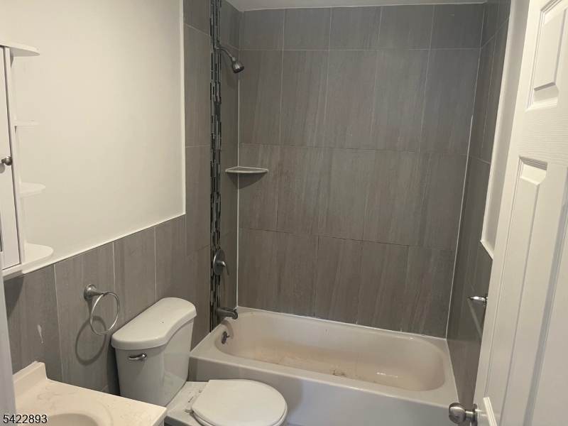 58 Wright Street, Unit 2 Newark, NJ 07114 - Photo 6 of 9 a bathroom with a toilet and a bathtub