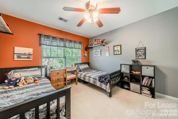 a bedroom with furniture and a window