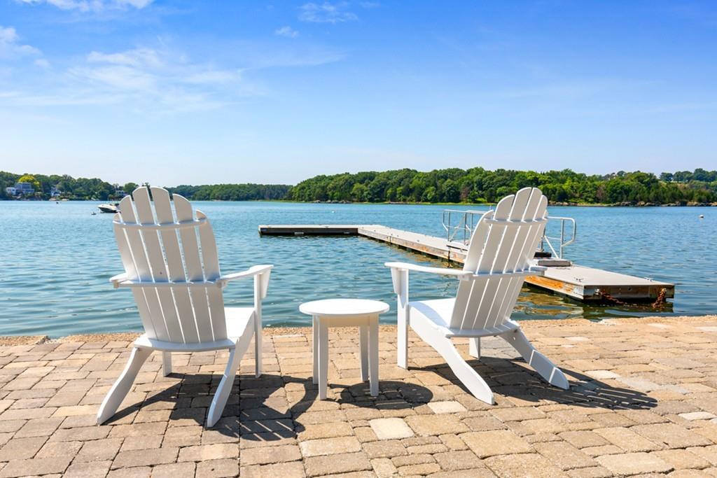 a view of a lake with a table and chairs