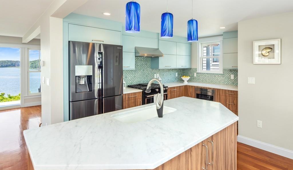 67 Hampton Circle Hull, MA 02045 - Photo 10 of 38 a kitchen with stainless steel appliances kitchen island a refrigerator and sink