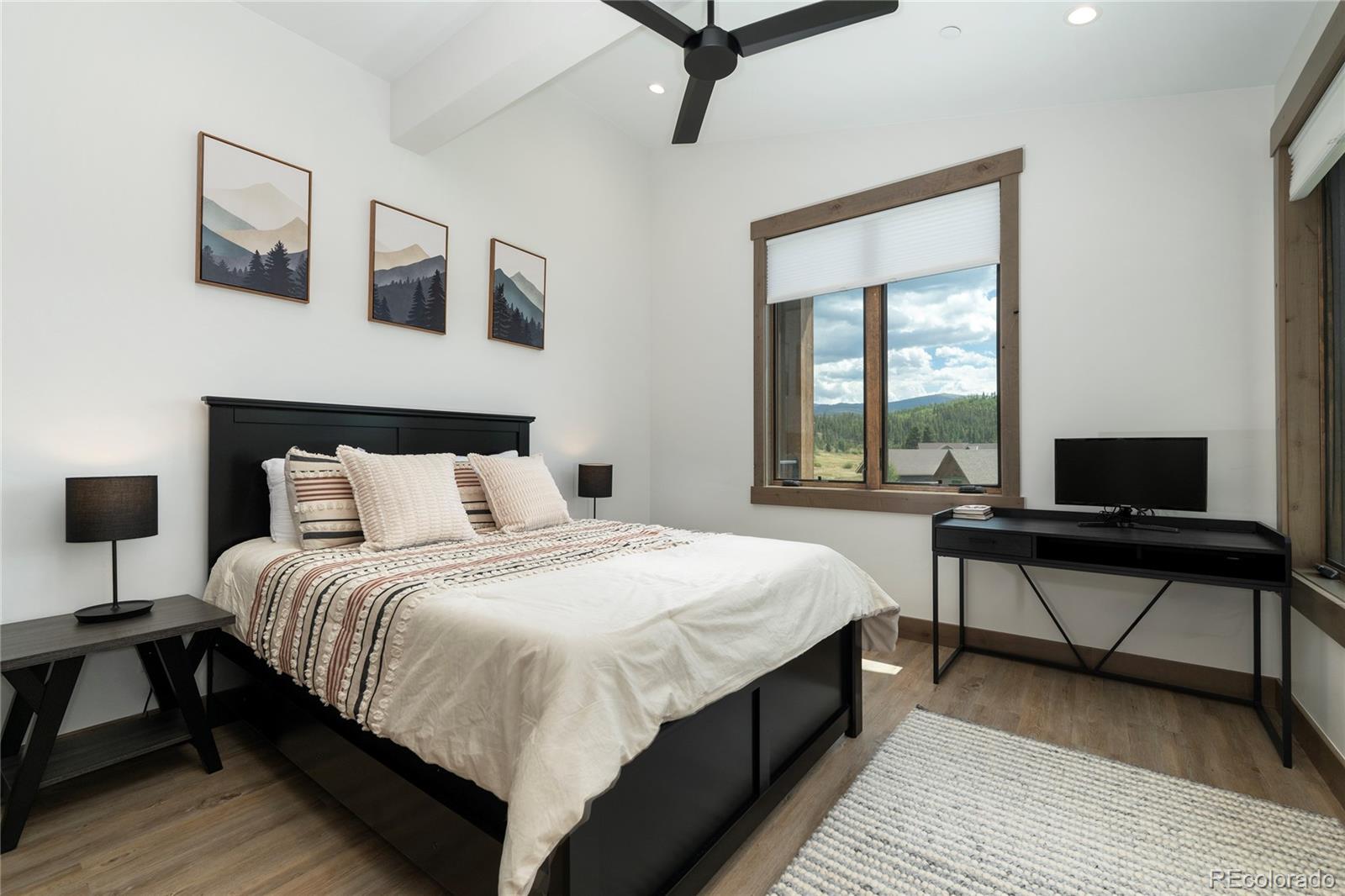 96 Meadow Trail, Unit G304 Fraser, CO 80442 - Photo 17 of 38 a bedroom with a bed a desk and chair