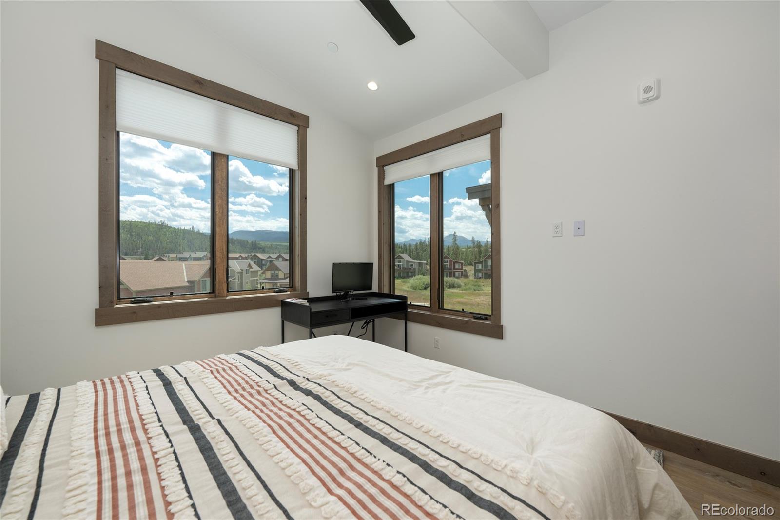 96 Meadow Trail, Unit G304 Fraser, CO 80442 - Photo 18 of 38 a bedroom with a bed and a window