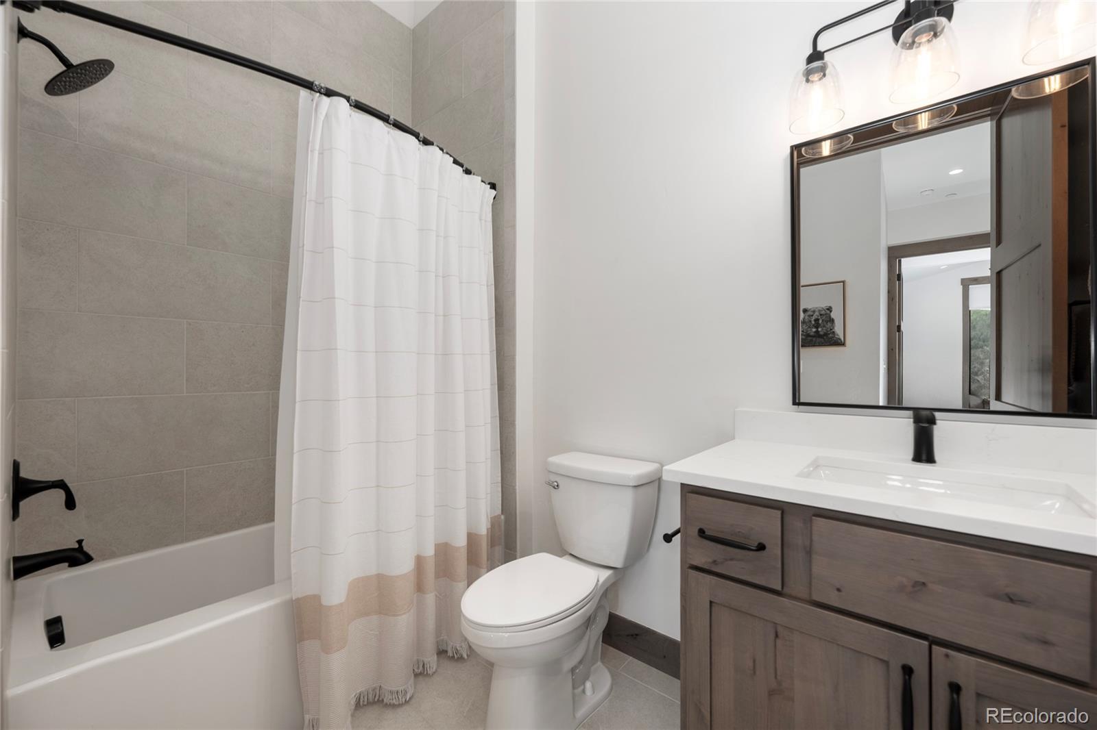 96 Meadow Trail, Unit G304 Fraser, CO 80442 - Photo 20 of 38 a bathroom with a sink toilet and shower
