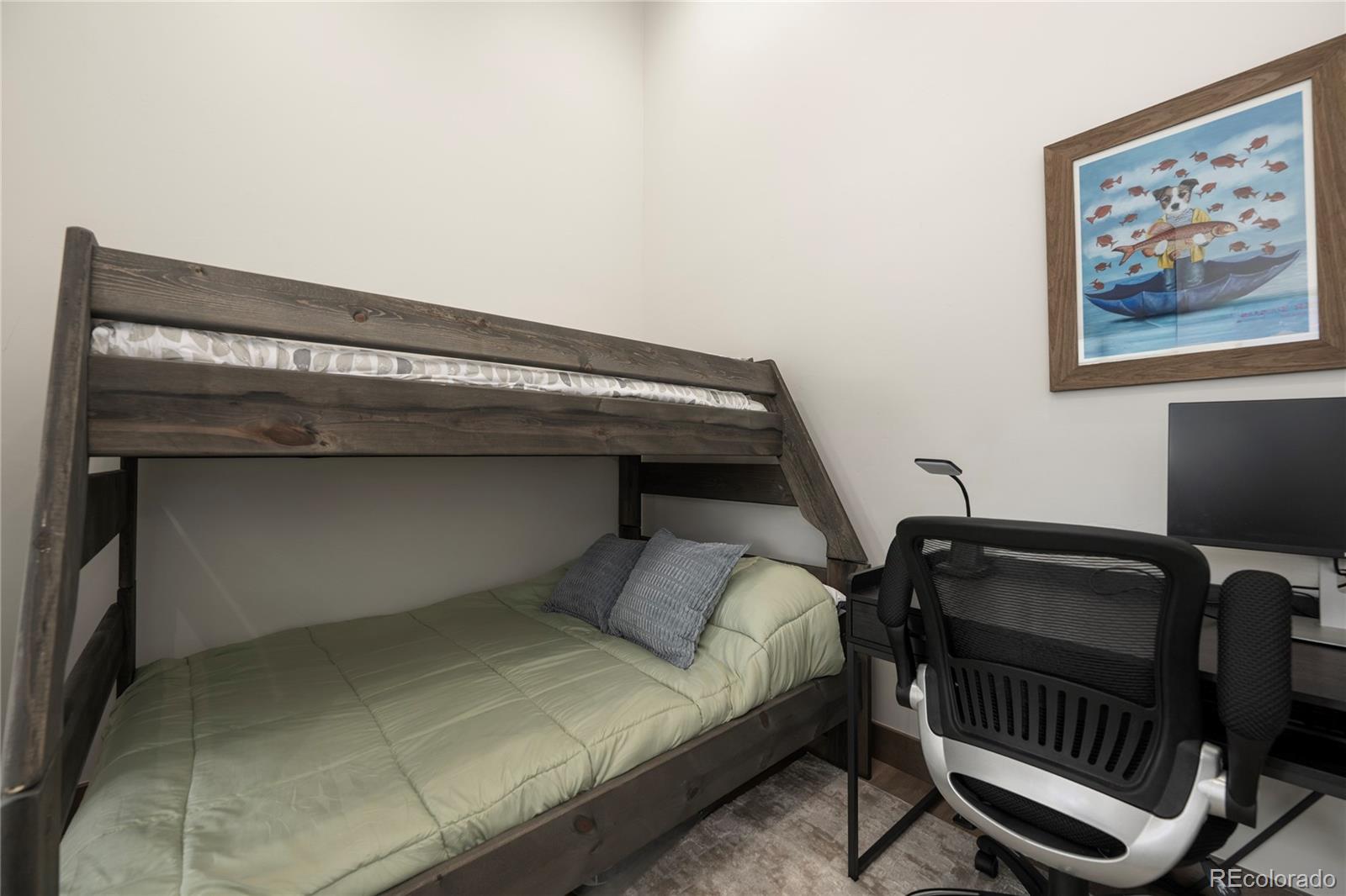 96 Meadow Trail, Unit G304 Fraser, CO 80442 - Photo 21 of 38 a bedroom with a bed and furniture