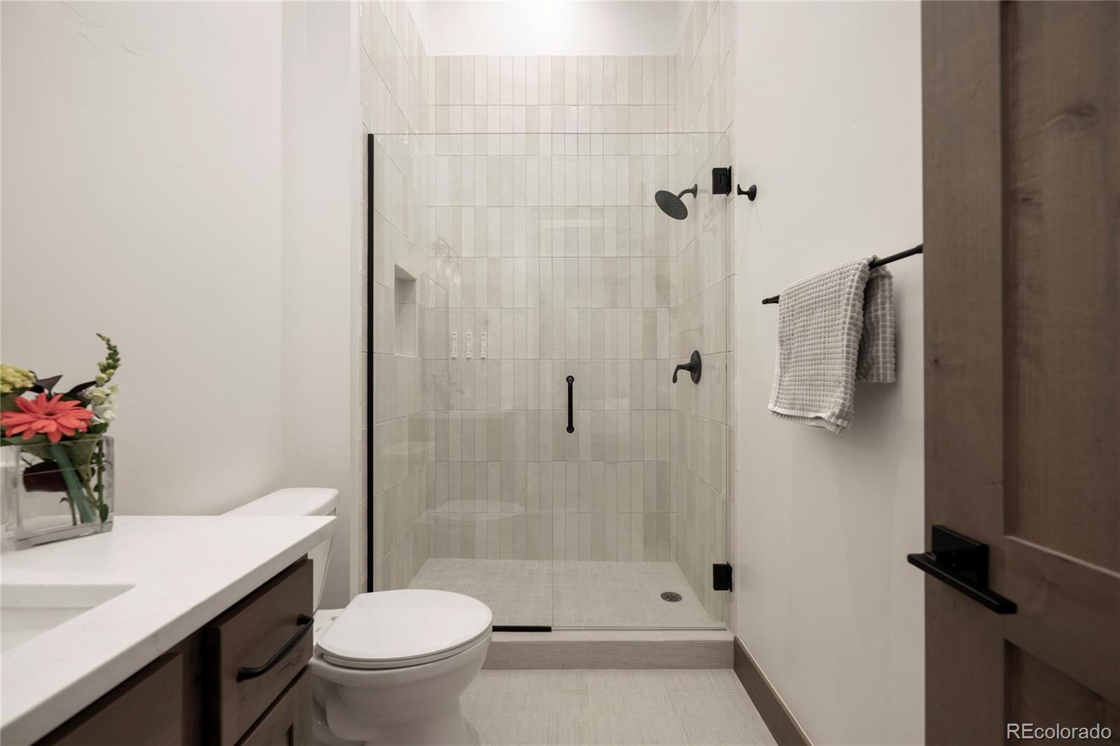 96 Meadow Trail, Unit G304 Fraser, CO 80442 - Photo 27 of 38 a bathroom with a sink toilet and shower