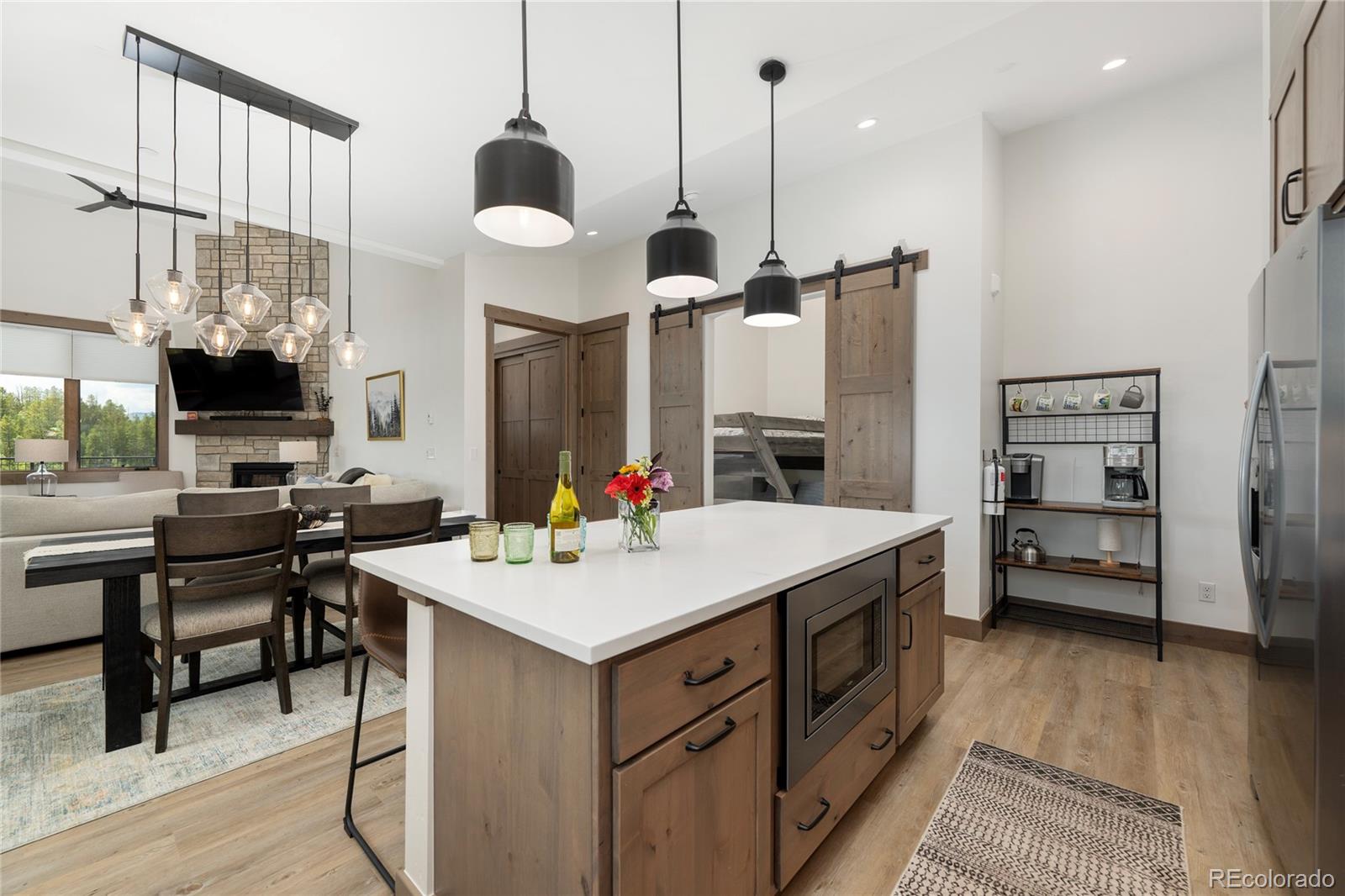 96 Meadow Trail, Unit G304 Fraser, CO 80442 - Photo 32 of 38 a kitchen with a sink a counter top space appliances and a chandelier