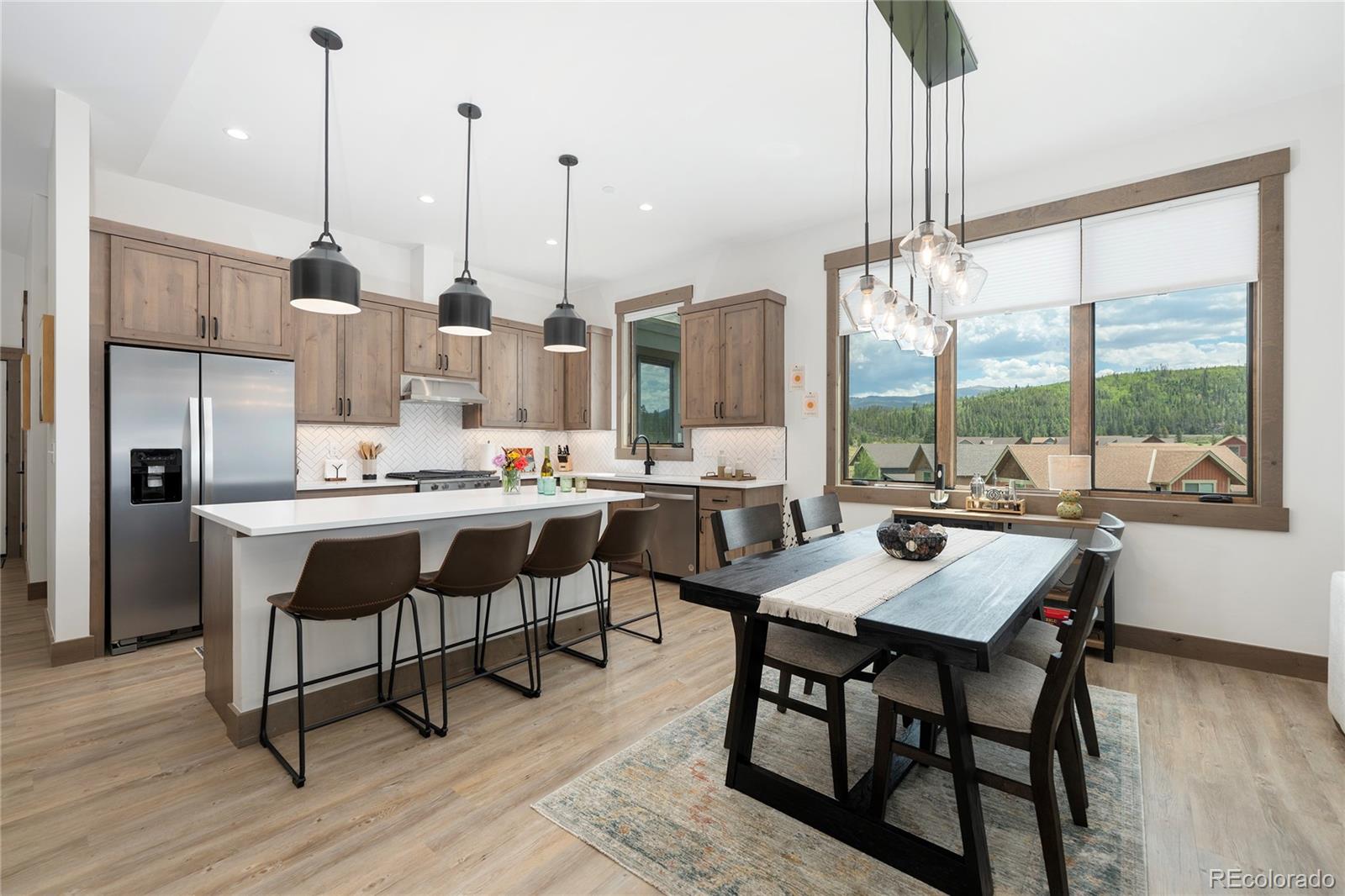 96 Meadow Trail, Unit G304 Fraser, CO 80442 - Photo 33 of 38 a dining room filled with furniture and a floor to ceiling window