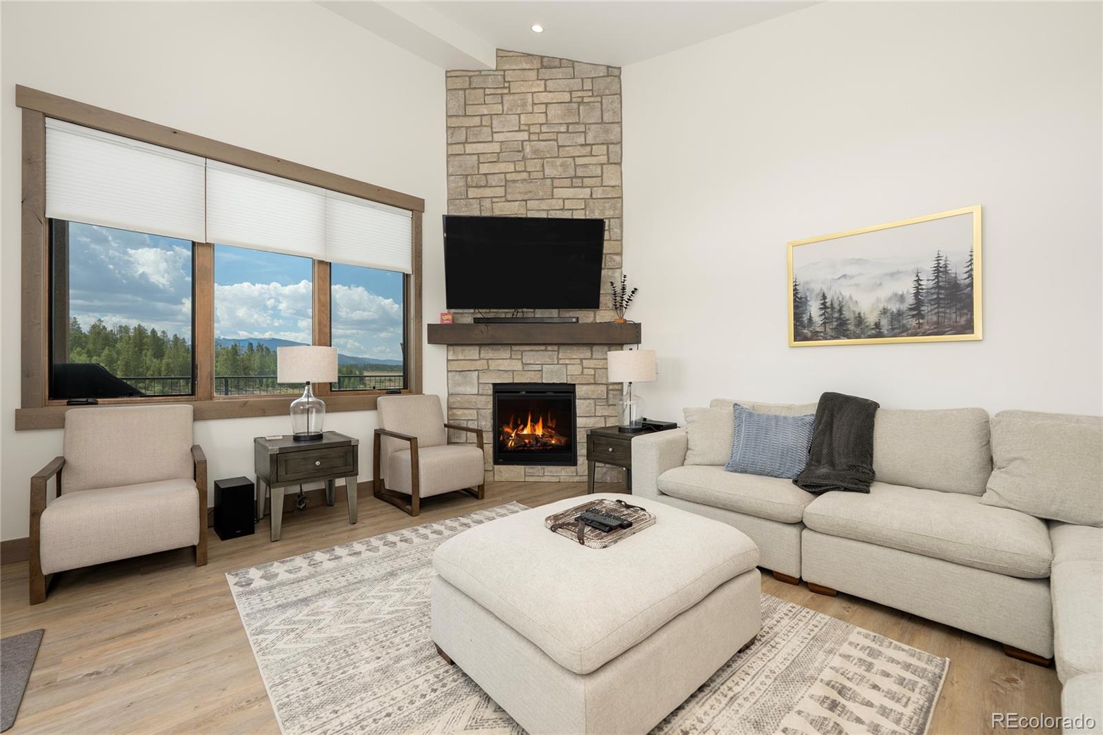 96 Meadow Trail, Unit G304 Fraser, CO 80442 - Photo 36 of 38 a living room with furniture a large window and a fireplace