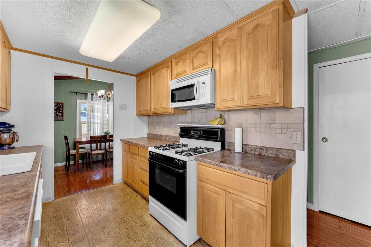 350 Gilmore Road Red Bluff, CA 96080 - Photo 8 of 27 a kitchen with a stove a sink and a microwave